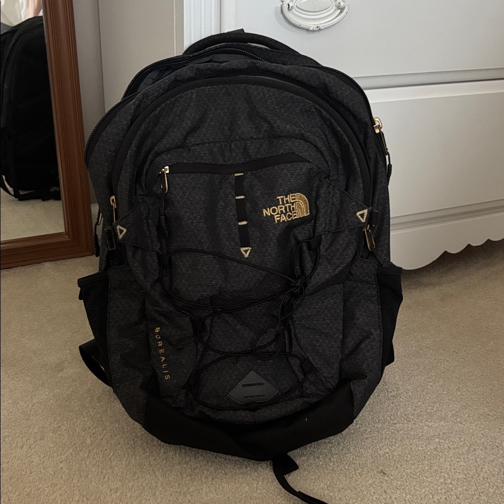The North Face Charcoal Backpack with Gold Accents